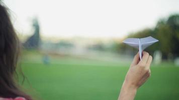 Woman holding a paper airplane video