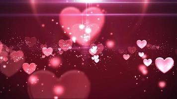 Pink blinking hearts fading and sparkling in a dark pink background video