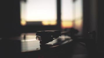 A record player spinning while the sun is setting video