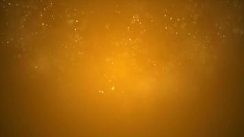 Loop of bright little particles floating on 4K golden background