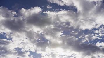 Time lapse of bright and gray altocumulus clouds moving from right to left in 4K video