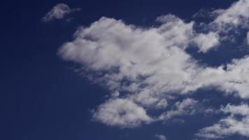 Time lapse of bright altocumulus clouds moving away from the camera in 4K video