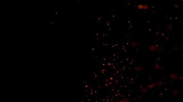 Orange texture of particles flashing and glowing on night sky in 4K video