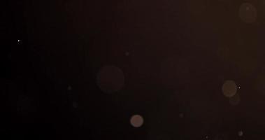 ljusa partiklar i förgrunden och bakgrunden flyter med slumpmässiga rörelser i 4k video