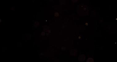 partículas brillantes suaves con efecto bokeh brillando y desapareciendo en la oscuridad en 4k video