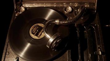 Medium shot top view of antique music device playing an old vynil disc in 4K video