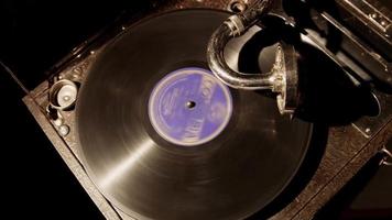 Medium static shot top view of classic music device playing a disc with purple label in 4K  video