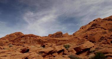 Short traveling shot of hill in desert landscape with cirrus clouds in 4K video