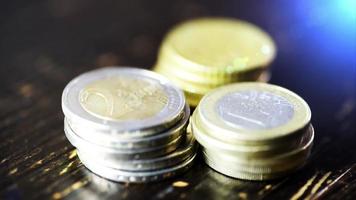 Euro coin on wooden table- financial power concept, closeup dolly shot
