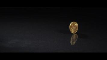 Spinning coin on a reflective surface - MONEY 0048 video