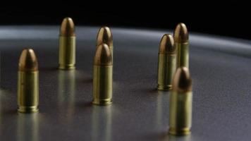 Cinematic rotating shot of bullets on a metallic surface - BULLETS 051 video