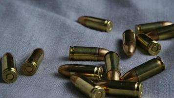 Cinematic rotating shot of bullets on a fabric surface - BULLETS 083 video