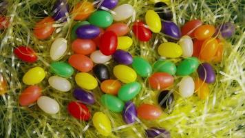 Rotating shot of Easter decorations and candy in colorful Easter grass - EASTER 009 video