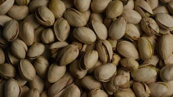 Cinematic, rotating shot of pistachios on a white surface - PISTACHIOS 028 video