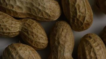 Cinematic, rotating shot of peanuts on a white surface - PEANUTS 006 video