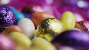 Foto giratoria de coloridos dulces de Pascua sobre un lecho de pasto de Pascua - Pascua 194 video