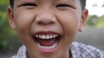 Close up little boy laughing and smile after hearing joke story video