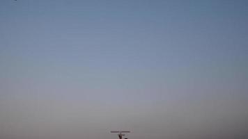 Boy running in a field and playing with a toy wooden airplane in his hands at sunset video