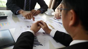 Business partners handshaking after signing contract at office. video