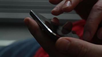 Man Stands Near Window In Hotel Room And Uses Smartphone video