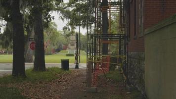 Handheld Clip Of Scaffolds In A Garden With A Park In Background video