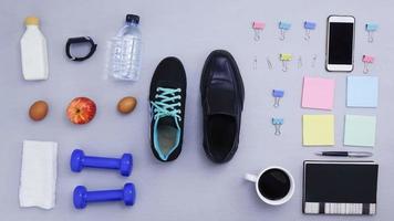 Objects for exercising and office coming on gray background. video