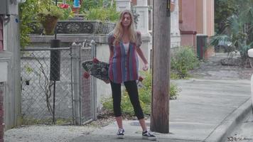 Handheld Clip Of Young Woman With A Longboard video
