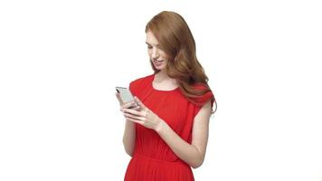 Young woman in a red dress using her phone video