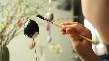 Young child painting easter eggs video