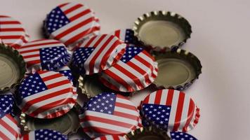 Rotating shot of bottle caps with the American flag printed on them - BOTTLE CAPS 032 video