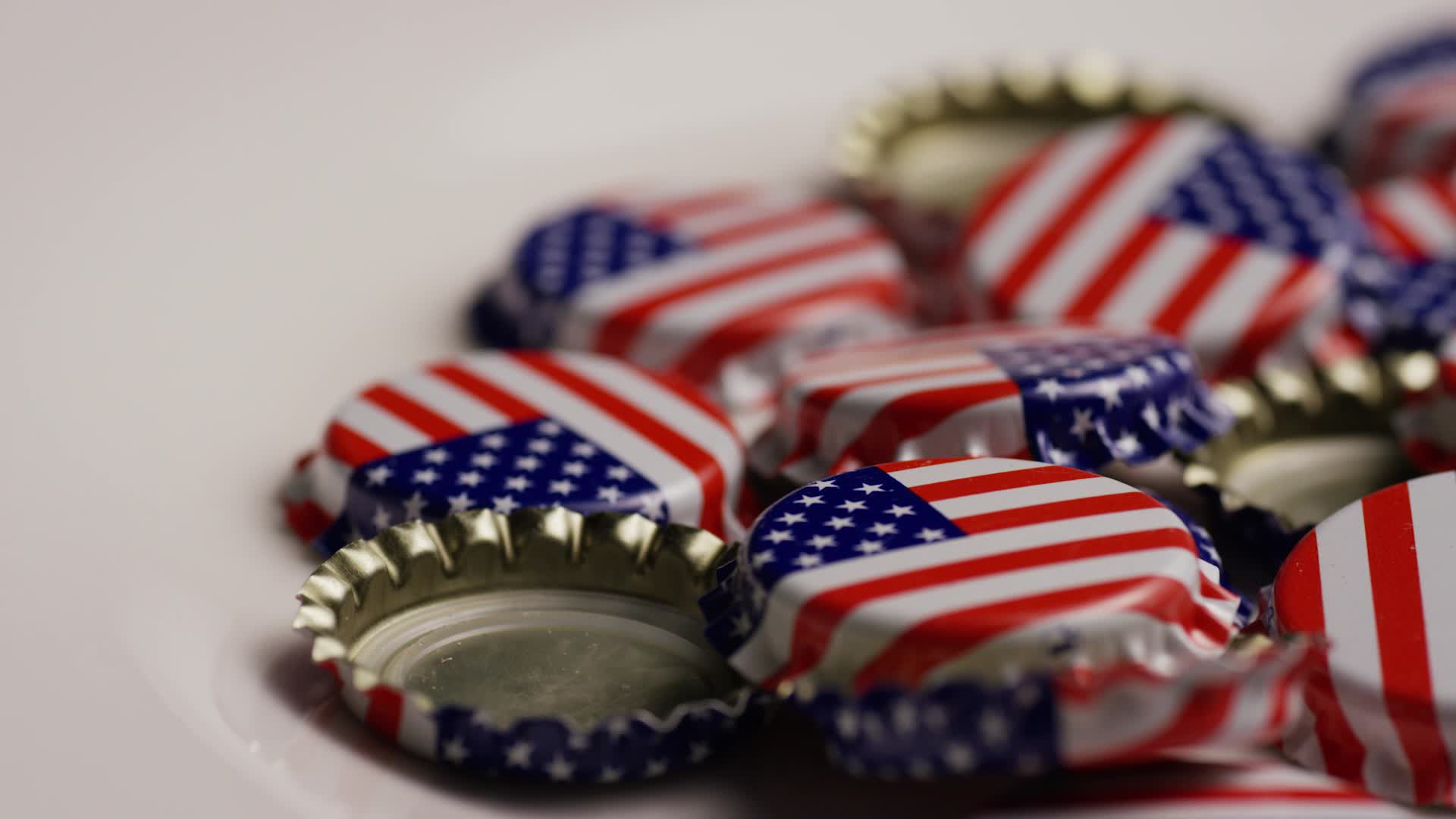 Rotating shot of bottle caps with the American flag printed on them