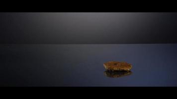 Falling cookies from above onto a reflective surface - COOKIES 187 video