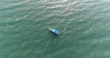 Top view of a blue boat sailing in the sea video