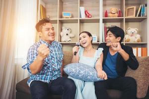 Group of friends singing a song together in their living room photo