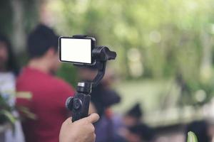 Hand holding gimbal with smartphone