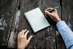 Woman writing in notebook photo