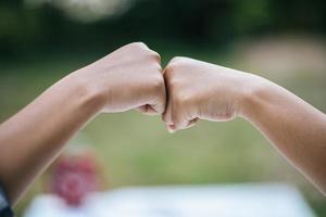 Close-up of students giving fist bump photo