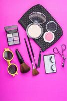 Cosmetic beauty products on pink background photo