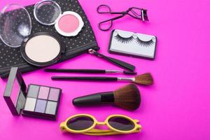 Cosmetic beauty products on pink background photo