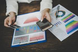 Woman using credit card and smart phone for online shopping photo