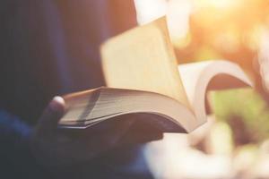 Man reading a book in his hands photo