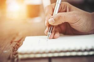 Woman writing in notebook photo