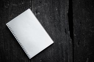 Notebook on wood texture background photo