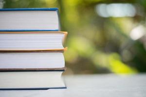 Stack of books on nature background photo