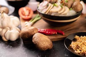 Shiitake mushrooms with garlic, tomato, capsicum and onions photo