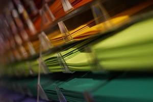 Rainbow colored papers in shelves photo