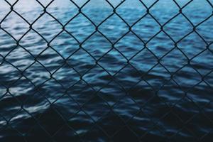 Water behind the chain link fence photo