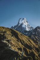 Two people at the base of a mountain photo