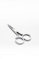 Metal scissors on a white background photo