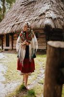 Young girl walks in the village in a traditional Ukrainian dress photo